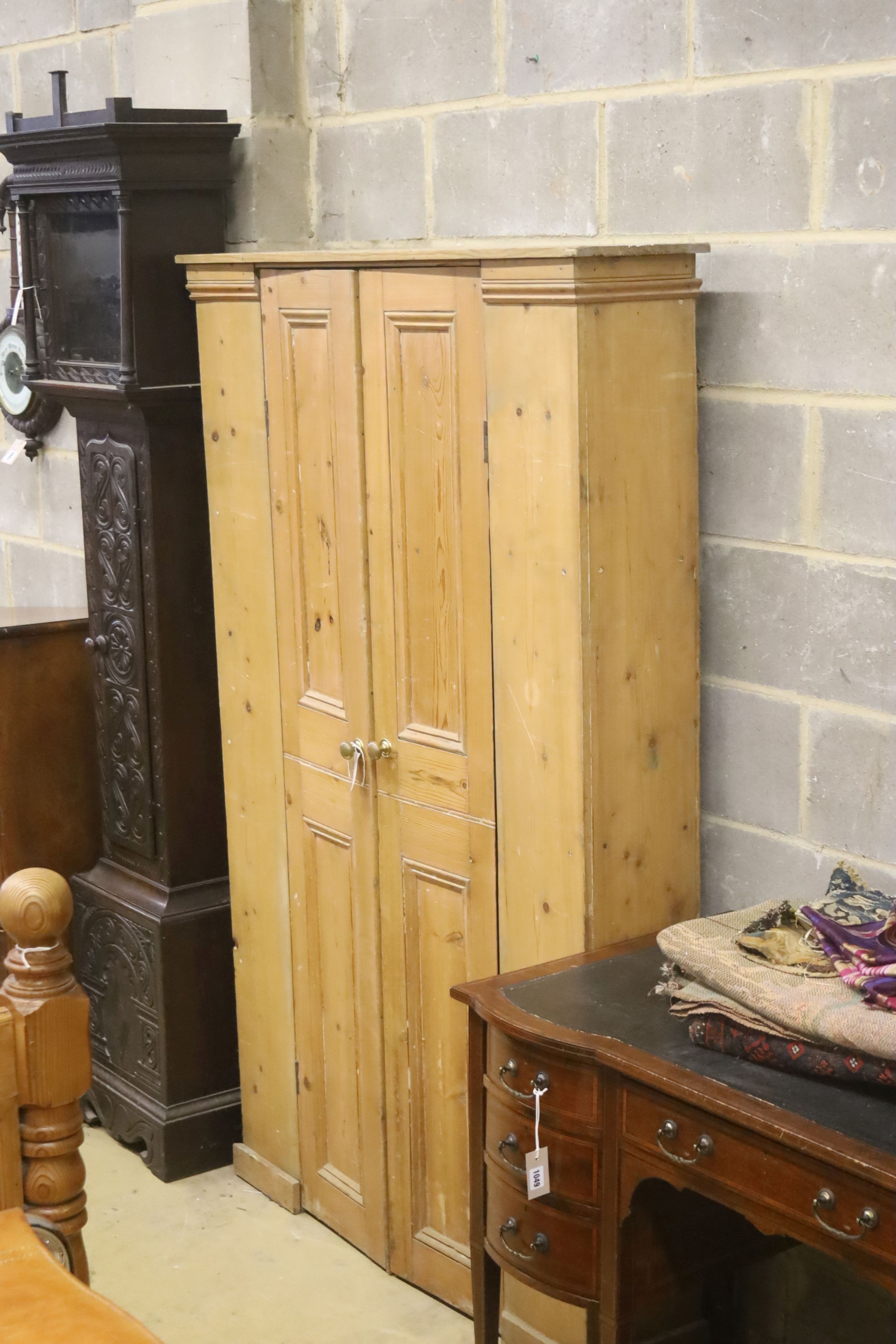 A Victorian pine two door cabinet, width 113cm, depth 25cm, height 181cm